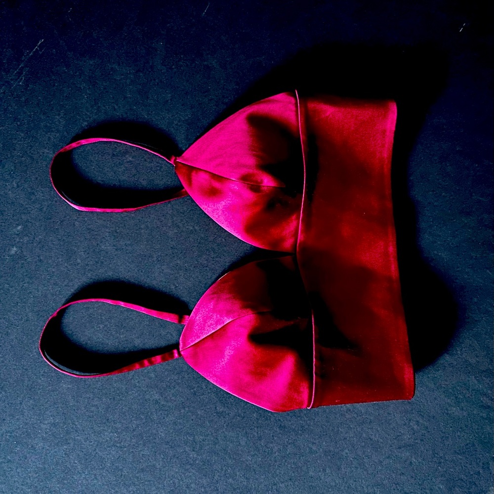 Subtle lingerie-inspired satin cami. Seamed cups, plunging neckline.
